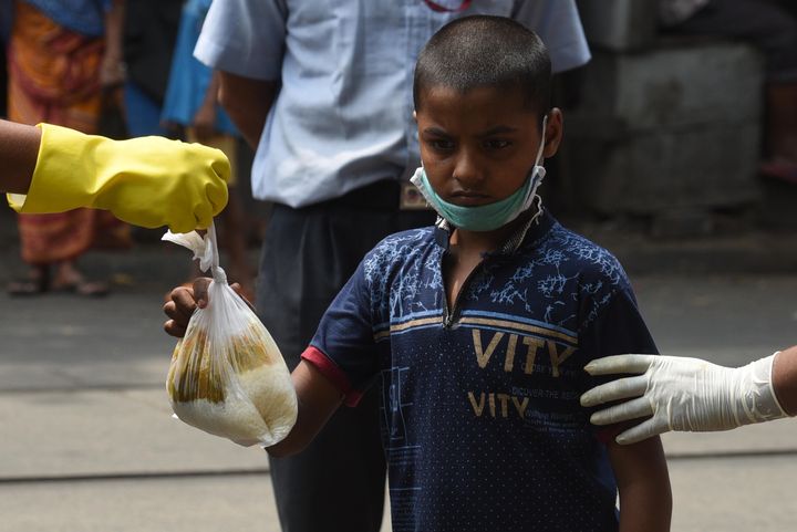 A child receives food during a meal distribution in Kolkata's College Street on May 4, 2020.
