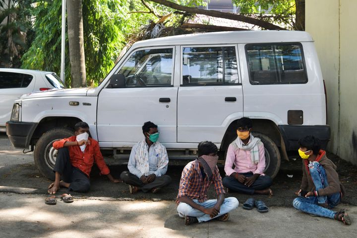 Migrant workers wait for transportation to leave for their hometowns in Bengaluru on April 30, 2020.