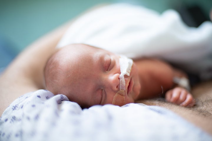 A father does skin-to-skin with his premature baby.