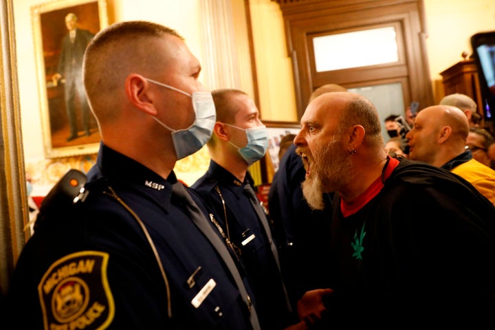 Protestors try to enter the Michigan House of Representative chamber and are being kept out by the Michigan State Police on A
