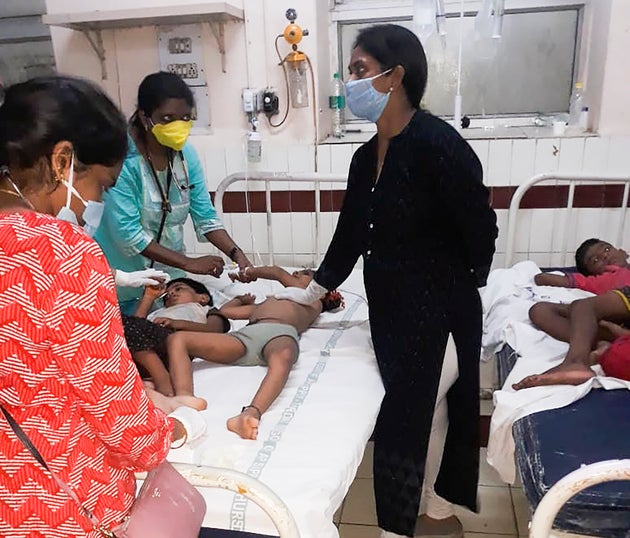 Staff attend to children affected by a gas leak from an LG Polymers plant at the King George hospital...