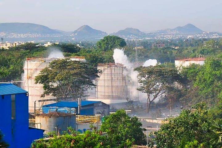 Smokes rise from an LG Polymers plant following a gas leak incident in Visakhapatnam on May 7, 2020. 