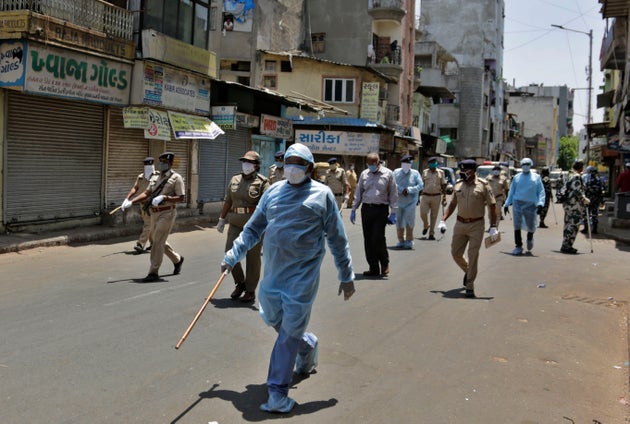 Police officials patrol a street during lockdown in Ahmedabad on April 19,