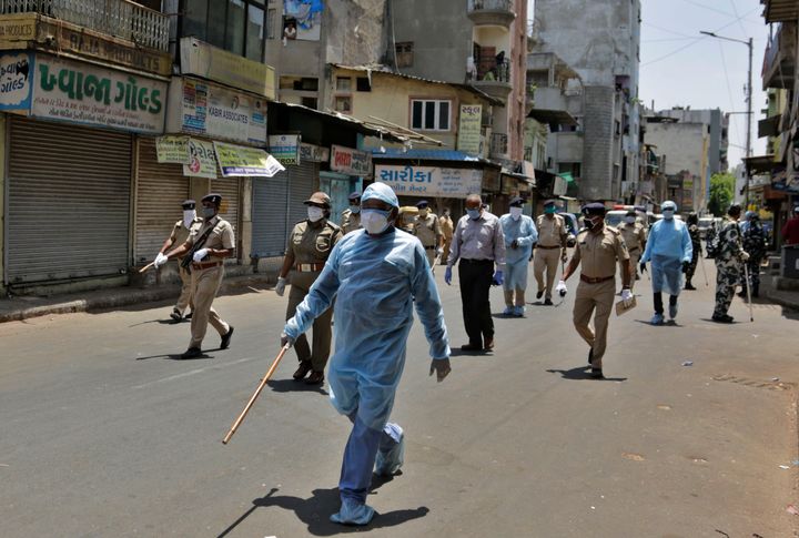 Police officials patrol a street during lockdown in Ahmedabad on April 19, 2020,
