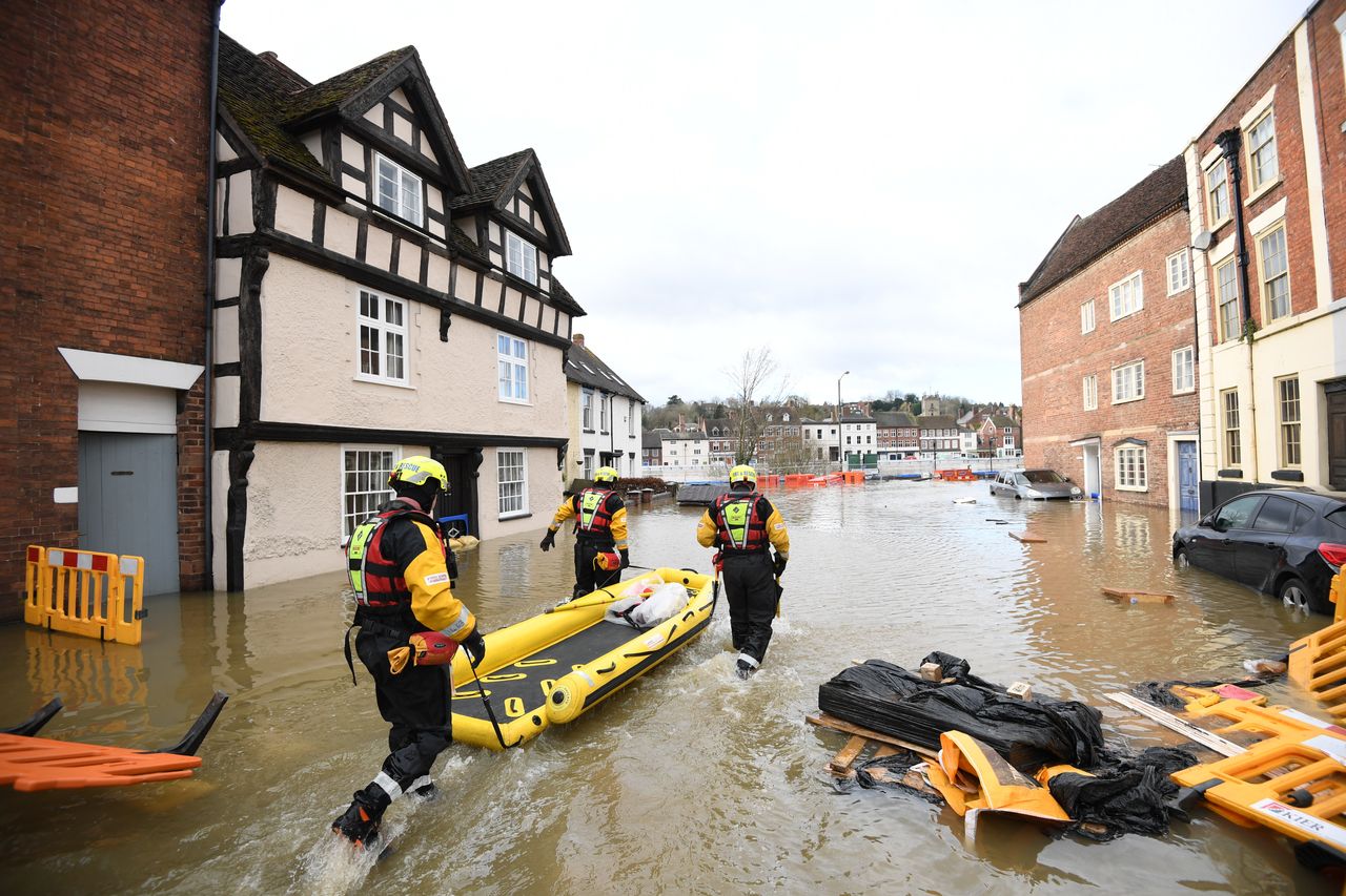 Fire and Rescue officers pull an inflatable raft in Bewdley, Worcestershire, earlier this year.