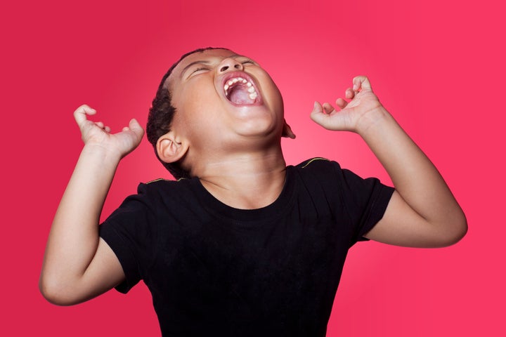 Angry Boy Screaming Against Pink Background