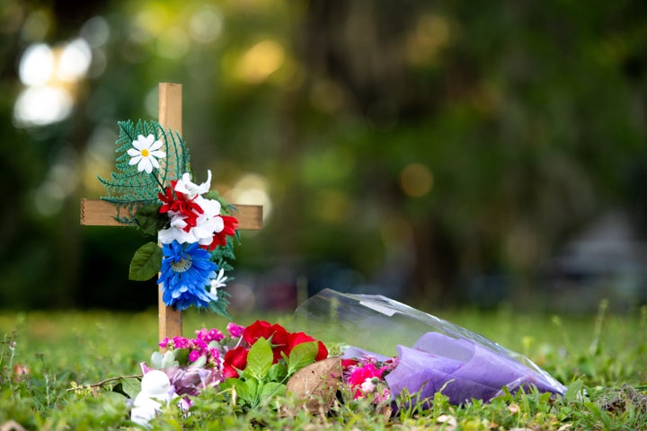 A cross with flowers sits near the intersection of Satilla Rd. and Holmes Rd. in the Satilla Shores neighborhood where Ahmaud Arbery was shot and killed May 7, 2020 in Brunswick, Georgia. Arbery was shot during a confrontation with an armed father and son on Feb. 23. (Photo by Sean Rayford/Getty Images)