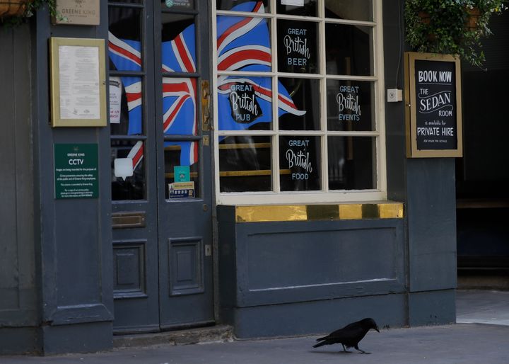 A Union flag in the window of a closed pub, as the country is in lockdown to prevent the spread of coronavirus, in London, Thursday, May 7, 2020. Unlike the mass street celebrations in 1945, surviving veterans are marking V-E Day this year in virus confinement, sharing memories with loved ones, instead of in the company of comrades on public parade. (AP Photo/Kirsty Wigglesworth)