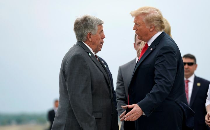 President Donald Trump speaks with Missouri Gov. Mike Parson (R) at a stop in St. Louis on July 26, 2018.
