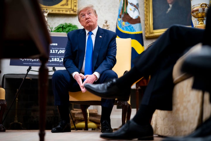 President Donald Trump talks to reporters while meeting with Iowa Gov. Kim Reynolds on May 6, 2020. Reynolds lifted some restrictions in 77 of her state's counties on May 1, allowing gyms, restaurants and retail stores to reopen.