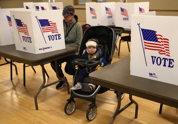 A Missouri mother casts her vote in the state's presidential primary on March 10 in St. Charles, Missouri. The exemptions that allow absentee voting in the state are limited.