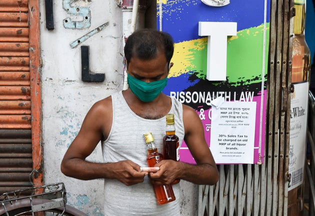 A man buys alcohol from a shop in Kolkata during the Covid-19 lockdown on May 7,
