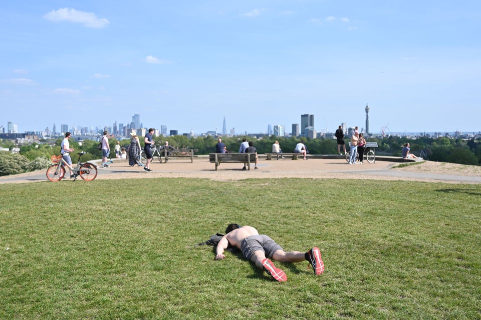 A man sunbathes on Primrose Hill in London during lockdown