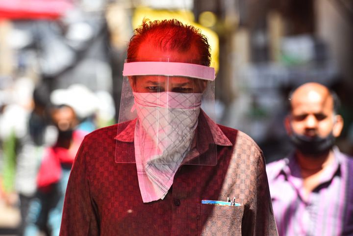 A man seen covering his face with face shield as a precautionary measure from coronavirus at Azadpur Mandi on May 7, 2020 in New Delhi, India.
