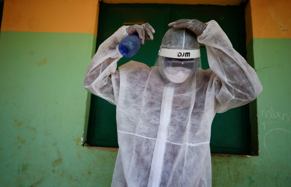 A health worker sprays his headset during a community testing exercise in Abuja, Nigeria. (REUTERS/Afolabi Sotunde)