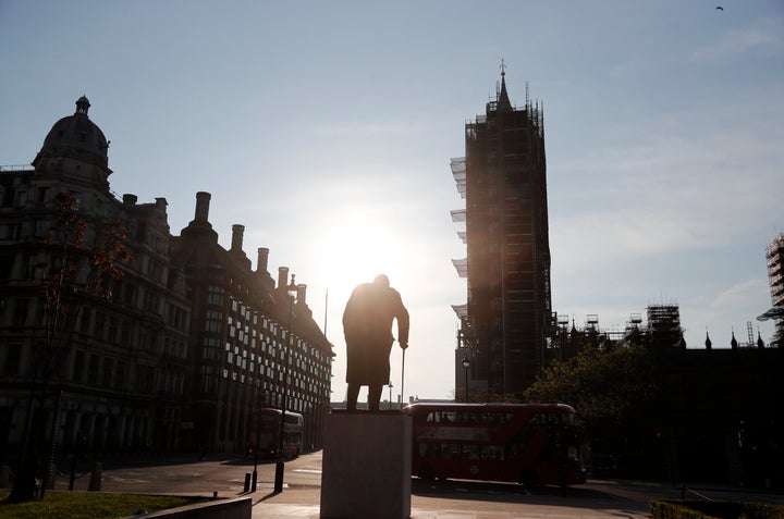 The statue of Britain's wartime Prime Minister Winston Churchill stands in an almost empty Parliament Square in London on VE Day 2020