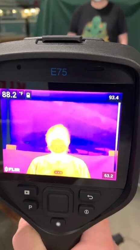 A FLIR thermal imaging camera being used in a Whole Foods store.