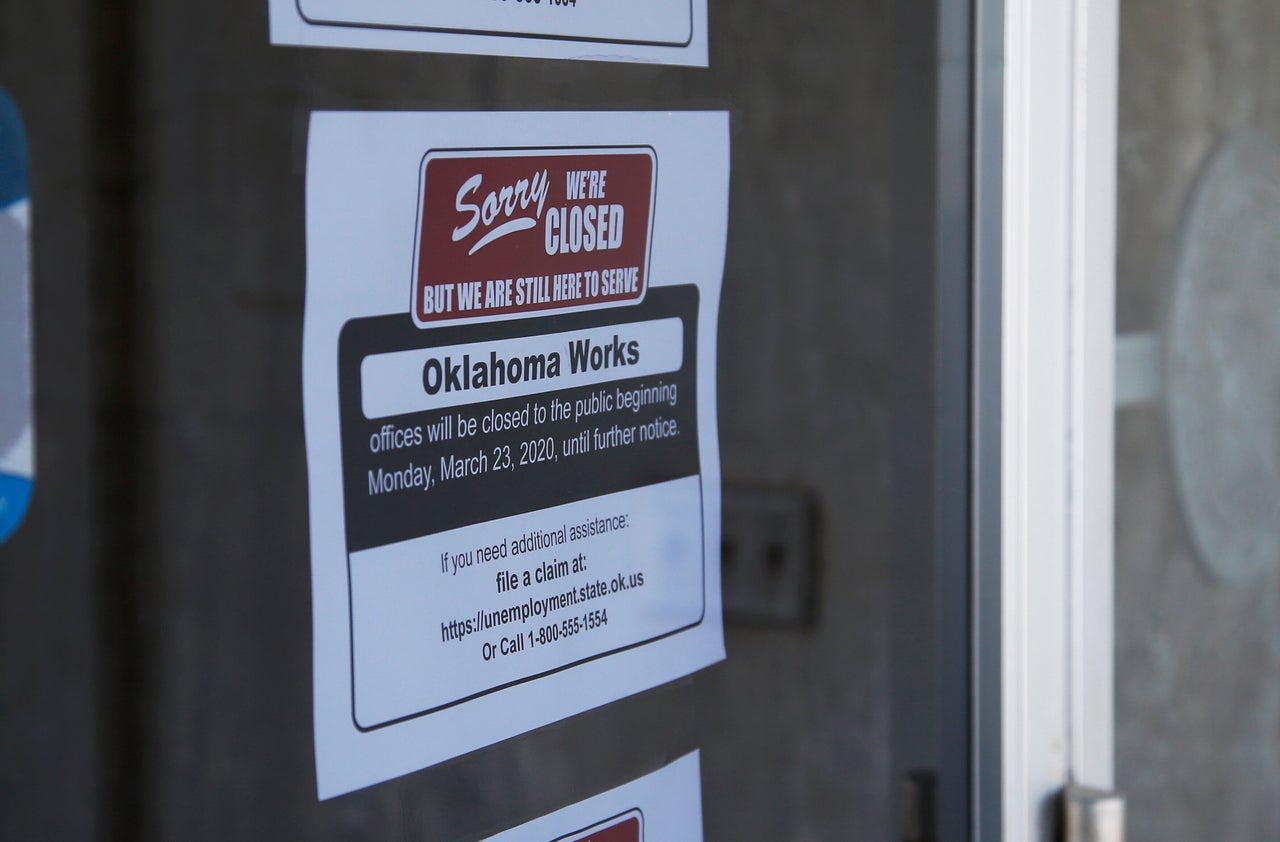 A sign at the Oklahoma Employment Security Commission offices in Oklahoma City states the offices are closed due to the coronavirus in an April photo.