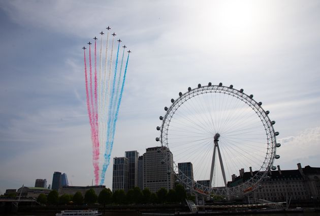 The Royal Air Force Red Arrows pass over the London Eye on the bank of the River Thames during a flypast in central London to mark the 75th anniversary of VE Day.