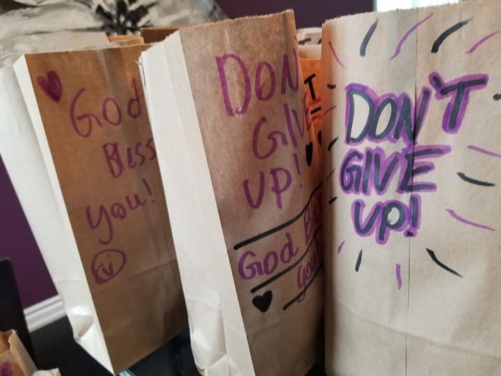 Antone's kids write inspiring messages on paper bags holding meals for recipients. 