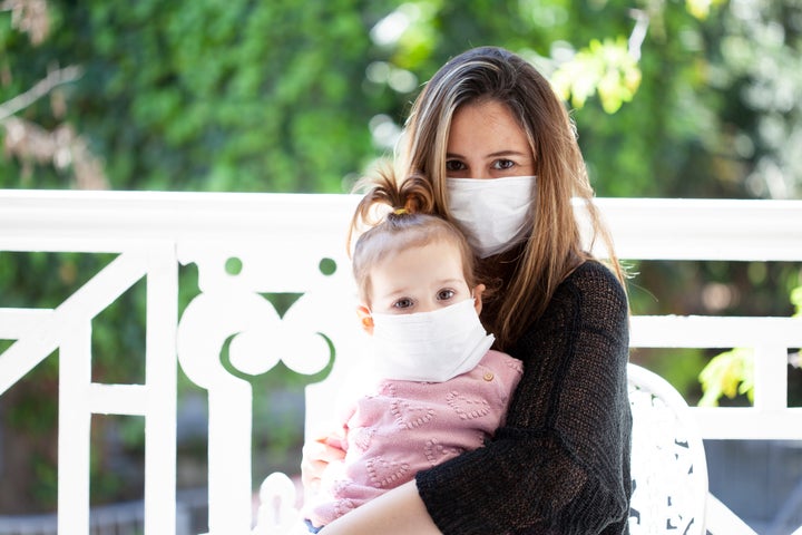 mother and baby wearing a medical mask