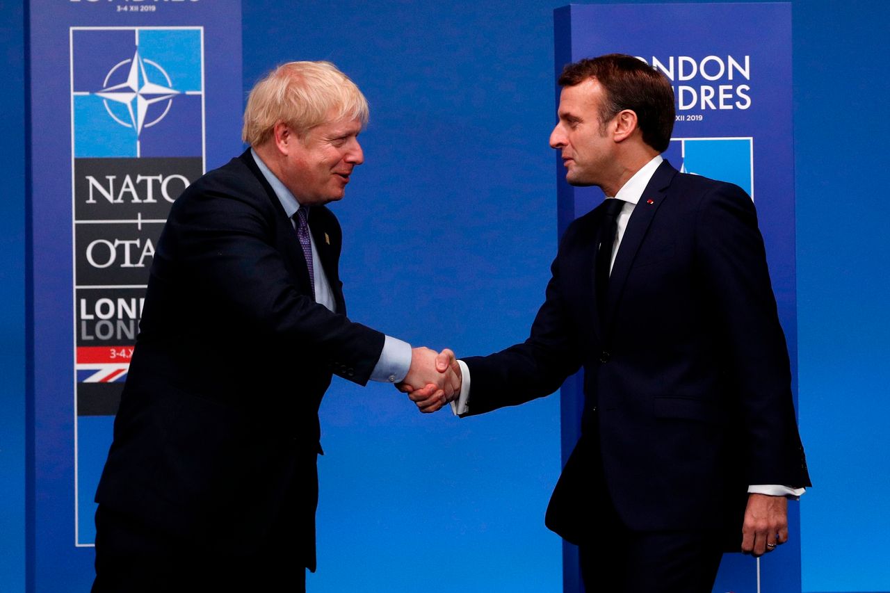 Boris Johnson greets French president Emmanuel Macron.