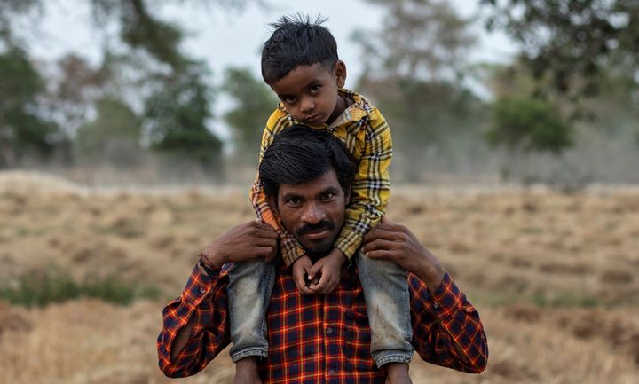 Dayaram Kushwaha, a migrant worker, with his 5-year-old son, Shivam, after he returned to his home from New Delhi to the Jugyai villageMadhya Pradesh, India, April 8, 2020.