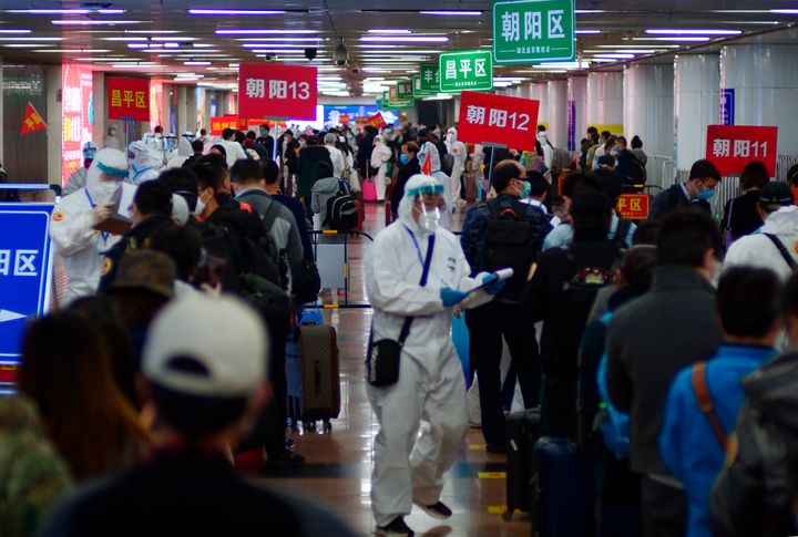 Passengers from Wuhan stand in lines designating where they will quarantine in Beijing, China, on April 15, 2020. 