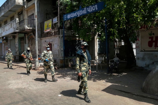 Border Security Force (BSF) soldiers patrol along a street during a government-imposed lockdown in Ahmedabad...