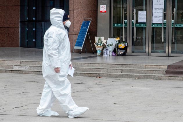 A medic walks past a hospital in Wuhan, China