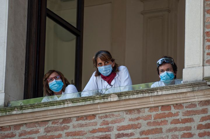 Doctors at the Padua Hospital wear protective masks