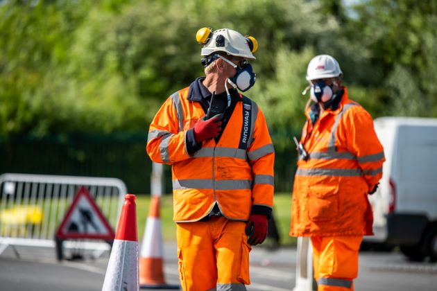 Traffic management staff direct motorists as they queue to enter Worcester East Household Recycling Centre as it reopens on Monday for the first time since the UK entered lockdown to reduce the spread of coronavirus