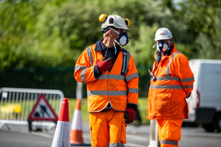 Traffic management staff direct motorists as they queue to enter Worcester East Household Recycling Centre as it reopens on Monday for the first time since the UK entered lockdown to reduce the spread of coronavirus