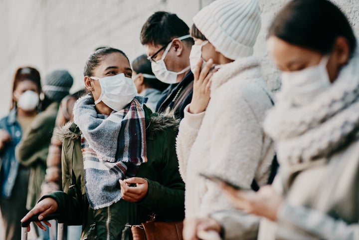 These people are standing WAY too close together for their masks to be effective.