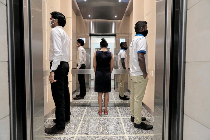 People practice social distancing inside an elevator in Colombo, Sri Lanka, on May 11.