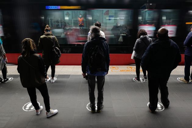 Commuters in Nice, France, wait on a tramway dock on May 11, abiding by the painted markers on the ground that help people maintain social distancing rules.