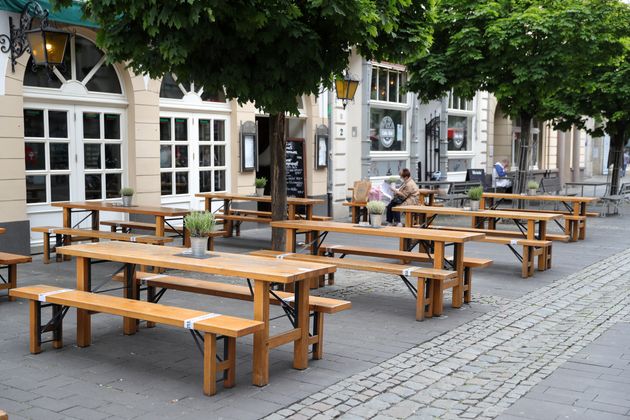 A customer sits outdoors a day after restaurants and cafes were allowed to reopen for the first time since March in Cologne, Germany.