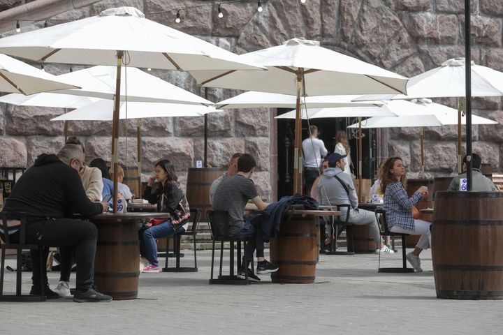 People dine outdoors in Kyiv, Ukraine, on May 11, 2020. Ukraine is allowing visits to parks, squares, recreational areas and some businesses as it starts a gradual exit from COVID-19 quarantine.