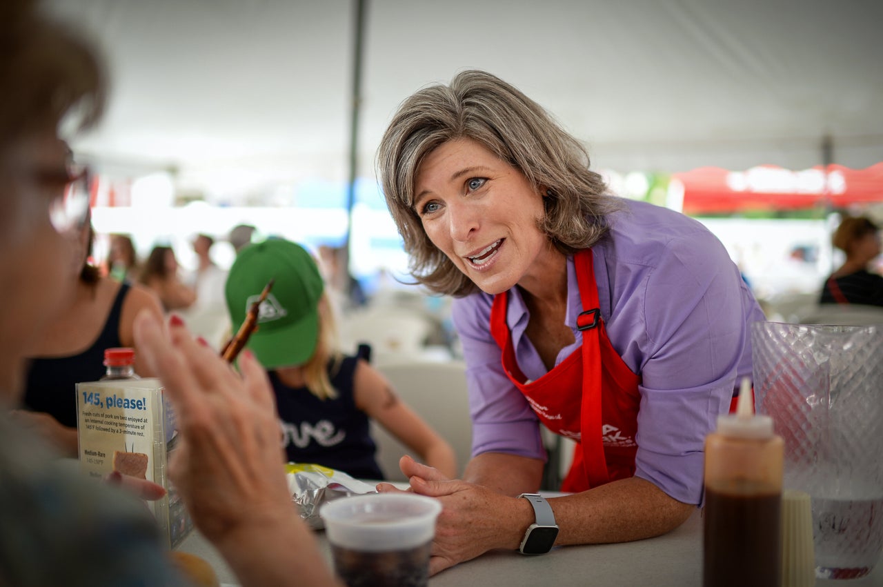 Sen. Joni Ernst talks to voters at the Iowa State Fair last August. Democrats are trying to capitalize on her suggestion that lawmakers reform Social Security "behind closed doors."