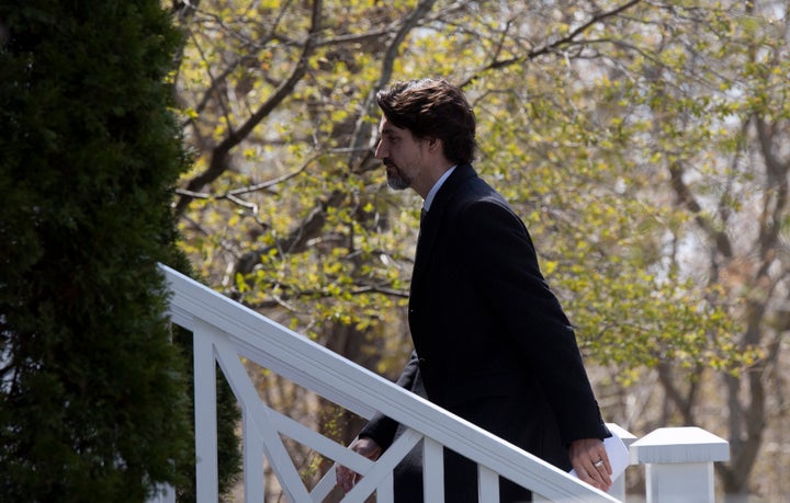 Prime Minister Justin Trudeau walks up the stairs as he returns to Rideau Cottage following a news conference outside Rideau
