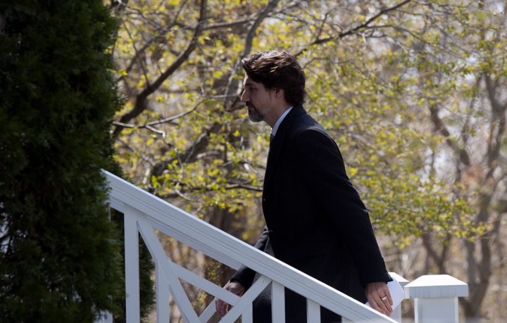 Prime Minister Justin Trudeau walks up the stairs as he returns to Rideau Cottage following a news conference outside Rideau Cottage on May 12, 2020 in Ottawa. 