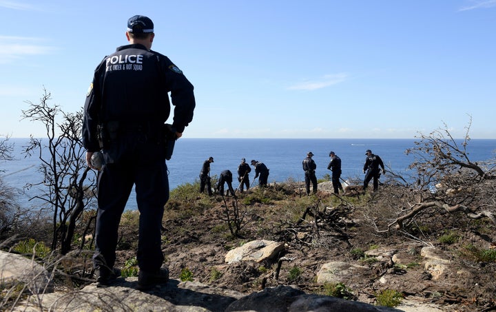 Police search near a cliff in the Sydney area on May 12, following an arrest related to the death of an American man in 1988.