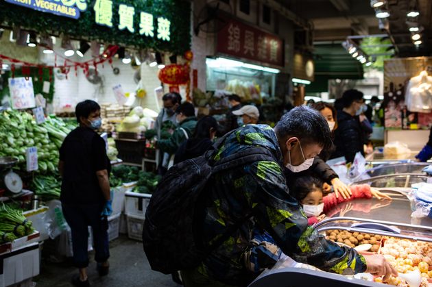 People shopping at a wet market as residents in Mei Foo in Hong Kong. 