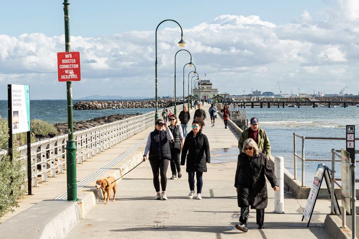 People walk along St Kilda Pier on May 13, 2020 in Melbourne, Australia. COVID-19 restrictions have eased slightly for Victorians in response to Australia's declining coronavirus (COVID-19) infection rate.