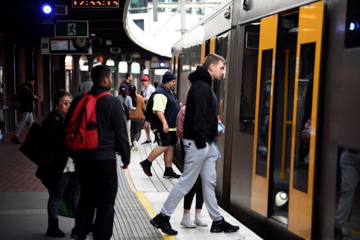 Passengers board a train in the central business district of Sydney on May 13, 2020. 