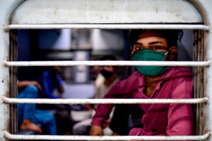 A migrant worker from Uttar Pradesh boards a train at Pune railway station on May 9, 2020. 