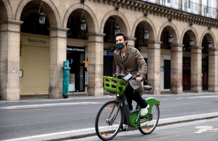A man wearing a face mask rides a Velib bicycle in the deserted and car-free "rue de Rivoli" in Paris, France, on May 5.
