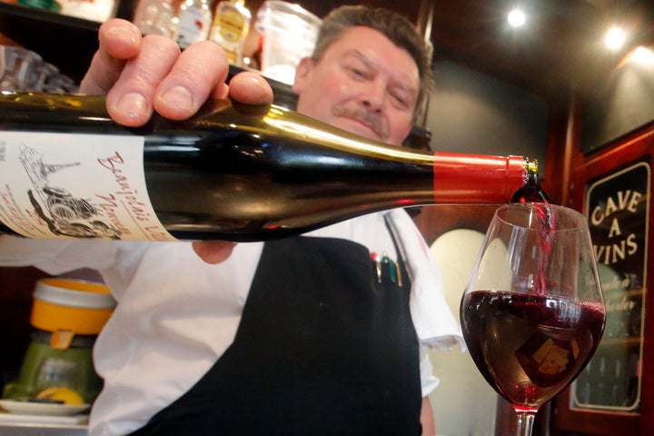 A bartender pours a Beaujolais Nouveau wine just outside of Paris. It's a ritual to uncork Beaujolais Nouveau on the third Thursday of every November.