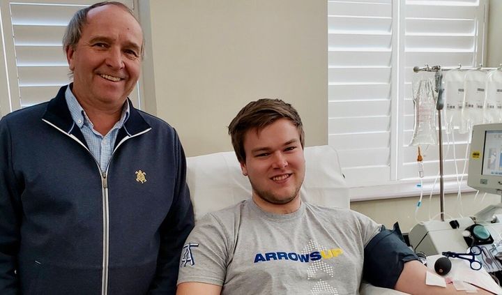 Richard Carl, left, with his son Patrick as he donates plasma to a clinical trial in Toronto on May 6, 2020.