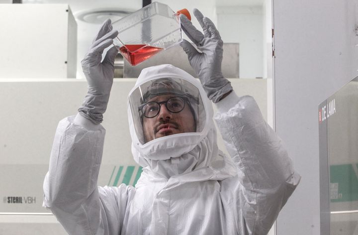 A bacteriologist performs an analysis of a COVID-19 serological test in a high security laboratory in Siena, Italy, on May12, 2020. 